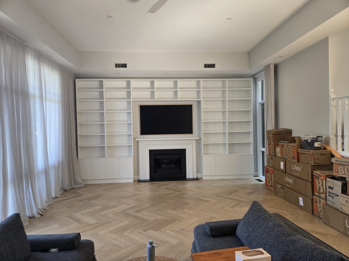 Custom built-in entertainment unit with shelving and fireplace